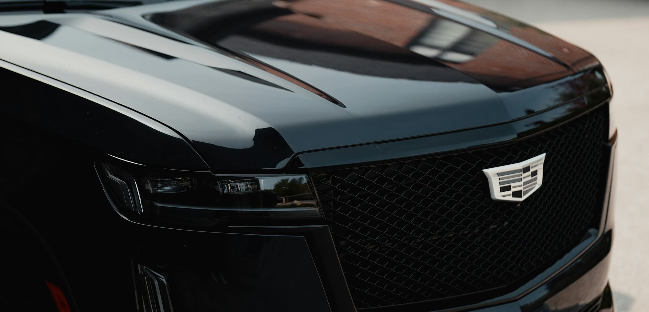 Close-up of the grille of a blacked-out Cadillac Escalade from the EPH Limousine fleet