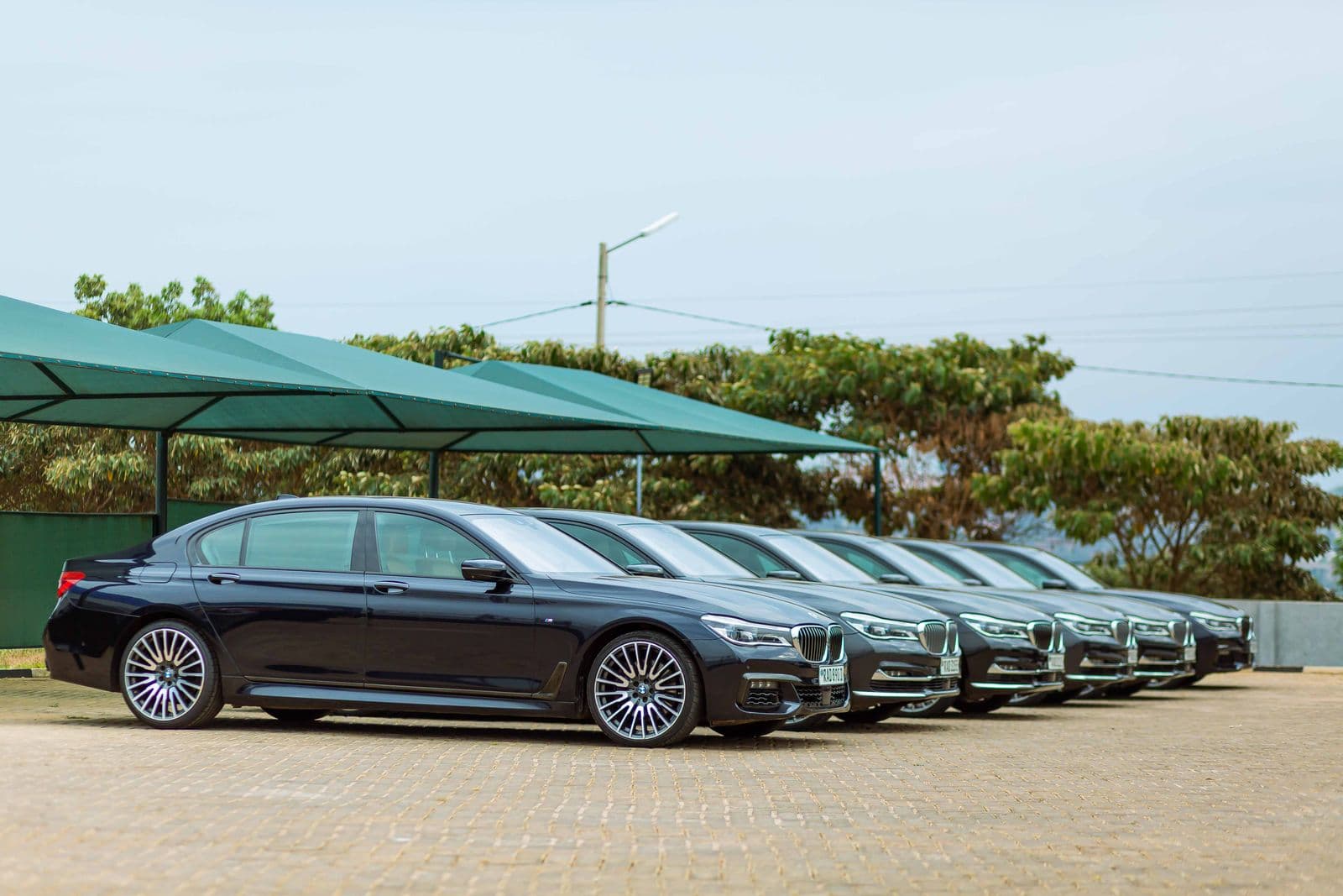 A lineup of black executive sedans ready for chauffeured hourly service